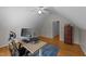 Home office with a sit-stand desk, blue rug, and hardwood floors at 903 Oldwyck Dr, Fuquay Varina, NC 27526