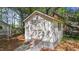Outbuilding with a ramp situated in a wooded area with a peek of the neighboring home at 903 Oldwyck Dr, Fuquay Varina, NC 27526