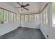 Bright sunroom with multiple windows, tile floors, and a ceiling fan at 903 Oldwyck Dr, Fuquay Varina, NC 27526