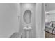 Compact bathroom features a pedestal sink, oval mirror and view into the living area at 918 E Green St # F105, Franklinton, NC 27525