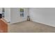 Bedroom with neutral carpet, white walls, one chair and a large window at 918 E Green St # F105, Franklinton, NC 27525