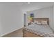 Bedroom features a comfortable bed with a patterned quilt and natural light from the window at 918 E Green St # F105, Franklinton, NC 27525