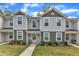 Charming townhome with gray vinyl siding, well-manicured landscaping, and inviting walkway at 918 E Green St # F105, Franklinton, NC 27525