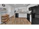 Modern kitchen features black appliances, white cabinets, and an open layout to the dining area at 918 E Green St # F105, Franklinton, NC 27525