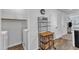 Bright laundry room with white washer, dryer and white cabinets at 918 E Green St # F105, Franklinton, NC 27525