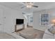 Neutral living room featuring plush seating, a TV, and natural light from the nearby window at 918 E Green St # F105, Franklinton, NC 27525