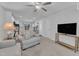 Cozy living room with neutral carpet, ceiling fan, and open access to the kitchen at 918 E Green St # F105, Franklinton, NC 27525