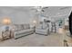 Bright living room featuring comfortable seating, ceiling fan, and open floor plan at 918 E Green St # F105, Franklinton, NC 27525