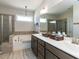 Bright bathroom featuring a double vanity, soaking tub, and a separate glass-enclosed shower at 937 Matterhorn Dr, Fuquay Varina, NC 27526
