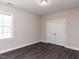 Bedroom with sleek laminate flooring, double door closet, and a bright window at 937 Matterhorn Dr, Fuquay Varina, NC 27526