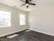 Bedroom featuring laminate flooring, two windows, and a ceiling fan at 937 Matterhorn Dr, Fuquay Varina, NC 27526