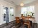 Cozy dining room featuring a modern light fixture, large windows, and dark wood flooring at 937 Matterhorn Dr, Fuquay Varina, NC 27526