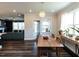 Bright dining room with modern light fixture, views to living room, and hardwood floors at 937 Matterhorn Dr, Fuquay Varina, NC 27526