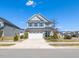 Charming two-story home with stone accents, a two-car garage, and well-maintained landscaping under a clear blue sky at 937 Matterhorn Dr, Fuquay Varina, NC 27526