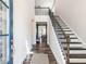 Bright and welcoming foyer with hardwood floors, staircase, and views into the adjacent dining room at 937 Matterhorn Dr, Fuquay Varina, NC 27526