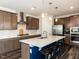 Spacious kitchen featuring a large island with seating, pendant lighting, and stainless steel appliances at 937 Matterhorn Dr, Fuquay Varina, NC 27526