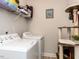 Laundry room with washer, dryer, wire shelf and cat tree at 937 Matterhorn Dr, Fuquay Varina, NC 27526