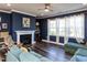 Inviting living room with a cozy fireplace, built-in bookshelves, and dark wood flooring at 937 Matterhorn Dr, Fuquay Varina, NC 27526