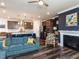 Open-concept living room features a fireplace, modern kitchen with an island, and dark hardwood floors at 937 Matterhorn Dr, Fuquay Varina, NC 27526