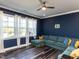 Bright living room featuring dark accent walls, plush seating, and large windows with natural light at 937 Matterhorn Dr, Fuquay Varina, NC 27526