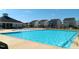 Inviting community pool with clear blue water, lounge chairs, and nearby clubhouse, perfect for summer relaxation at 937 Matterhorn Dr, Fuquay Varina, NC 27526