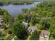 Stunning aerial view of waterfront home with lake access surrounded by lush greenery at 959 Sagamore Dr, Louisburg, NC 27549