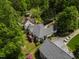 An aerial view showing a house with a deck and lush green tree surroundings at 959 Sagamore Dr, Louisburg, NC 27549