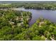 High angle aerial view of the lakefront property and lush green surroundings at 959 Sagamore Dr, Louisburg, NC 27549