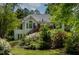 Exterior view of a home showcasing a deck and vibrant landscaping at 959 Sagamore Dr, Louisburg, NC 27549
