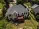 Aerial view of a house with a deck overlooking a well-manicured backyard at 959 Sagamore Dr, Louisburg, NC 27549