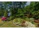 Lush backyard with flowers and a peek of the water as seen from above at 959 Sagamore Dr, Louisburg, NC 27549