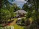 A spacious backyard view of a house with a wood deck and colorful landscaping at 959 Sagamore Dr, Louisburg, NC 27549