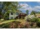 Spacious backyard with a deck, mature trees and lush landscaping; perfect for entertaining or relaxing at 959 Sagamore Dr, Louisburg, NC 27549