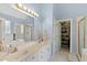 Bright primary bathroom featuring double sinks, walk-in closet and separate tub and shower at 959 Sagamore Dr, Louisburg, NC 27549