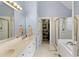 Bright bathroom with double vanities, a walk-in shower, and a well-organized closet at 959 Sagamore Dr, Louisburg, NC 27549