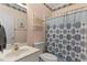Charming bathroom with a vanity, toilet, and shower featuring a patterned curtain at 959 Sagamore Dr, Louisburg, NC 27549