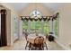Sunlit breakfast nook with a round table set by large windows offering a beautiful green view at 959 Sagamore Dr, Louisburg, NC 27549