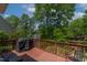 Outdoor deck area with a grill and scenic view of the water surrounded by lush greenery at 959 Sagamore Dr, Louisburg, NC 27549