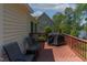 Outdoor deck with seating and a grill overlooking backyard and the lake at 959 Sagamore Dr, Louisburg, NC 27549