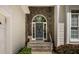 A inviting front door featuring stone accents and a colorful wreath at 959 Sagamore Dr, Louisburg, NC 27549