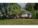 A quaint home featuring a well-kept lawn, mature trees, and a inviting façade at 959 Sagamore Dr, Louisburg, NC 27549