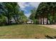 A charming single-Gathering home with a well-manicured lawn and mature trees at 959 Sagamore Dr, Louisburg, NC 27549