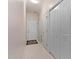 Hallway featuring multiple closets, white trim and neutral paint at 959 Sagamore Dr, Louisburg, NC 27549