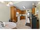 Open kitchen with ample cabinet space, white appliances, and view into an adjacent dining area at 959 Sagamore Dr, Louisburg, NC 27549