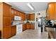 Traditional kitchen featuring wood cabinetry, white appliances, and neutral countertops at 959 Sagamore Dr, Louisburg, NC 27549
