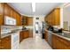 Traditional kitchen featuring wood cabinetry, white appliances, and neutral countertops at 959 Sagamore Dr, Louisburg, NC 27549