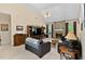Inviting living room featuring a stone fireplace, entertainment center, piano, and neutral tones at 959 Sagamore Dr, Louisburg, NC 27549