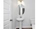 Powder bathroom with pedestal sink and oval mirror at 4868 Pioneer Dr, Sanford, NC 27330