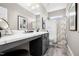 Bright bathroom features a granite vanity with storage and shower-tub combination at 4868 Pioneer Dr, Sanford, NC 27330