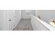 Upstairs hallway with carpet flooring and many doors at 4868 Pioneer Dr, Sanford, NC 27330